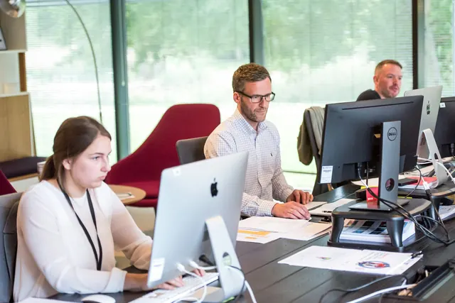 Support agents answering customers in the office