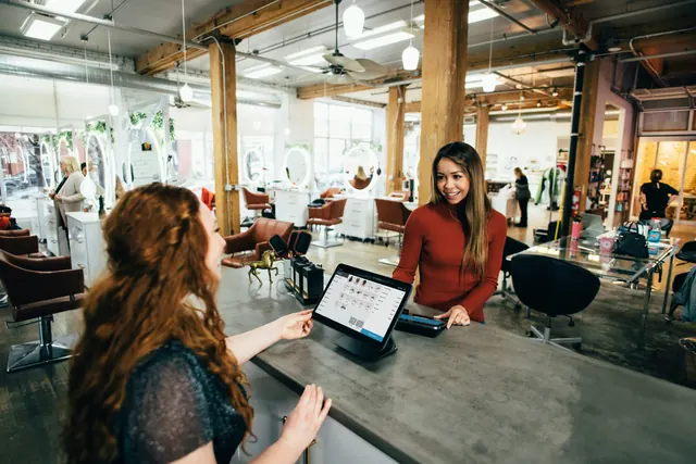 Shop assistant helping a customer at the counter