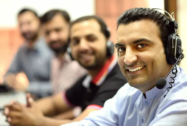 Customer support team with headsets using live chat